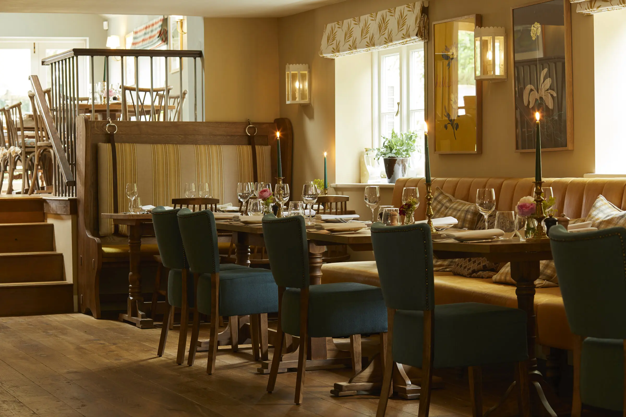 The long dining table laid with candles